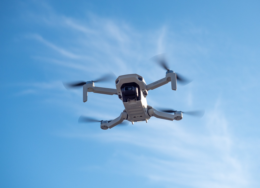 FPV pursuit shot of a rider in a dense mountain forest